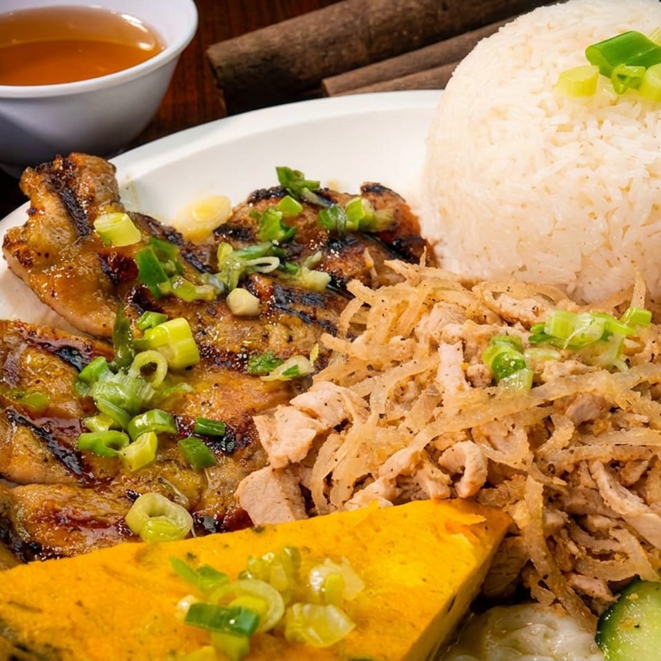 Grilled chicken, rice, shredded pork, pickled vegetables, and egg cake with dipping sauces.